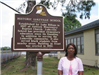 Woman standing in front of the historical marker
