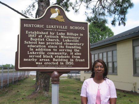 Woman standing in front of the historical marker