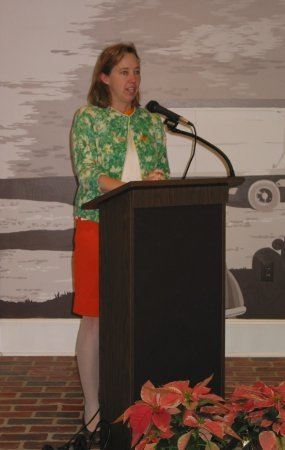 Woman speaking at podium during dedication